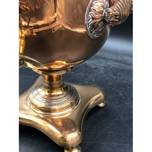 1003 - A brass and copper 2 handled samovar, on a shaped quatrefoil base and bun feet 36.5cm h.