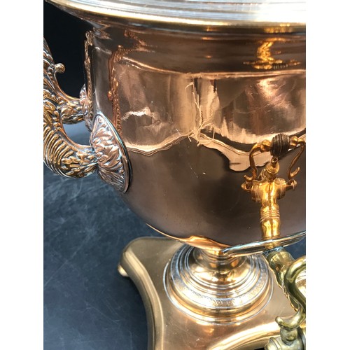 1003 - A brass and copper 2 handled samovar, on a shaped quatrefoil base and bun feet 36.5cm h.