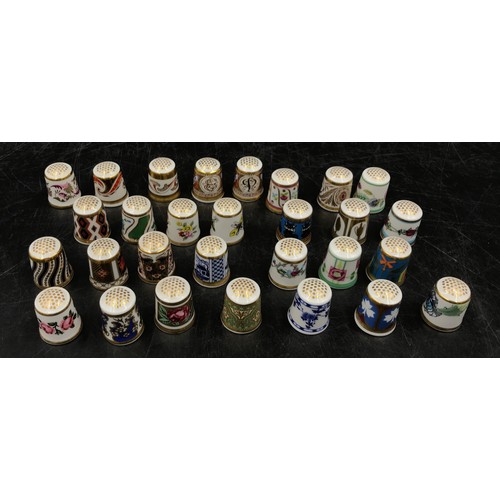 213 - A collection of ceramic thimbles to include 15x Royal Crown Derby all with certificates, a pair of l... 