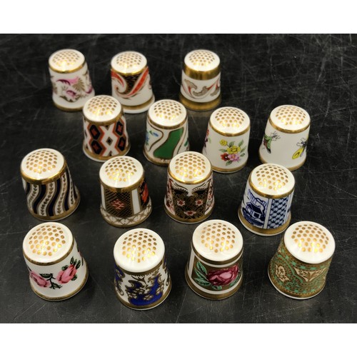 213 - A collection of ceramic thimbles to include 15x Royal Crown Derby all with certificates, a pair of l... 