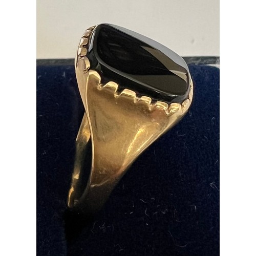 403 - A 9 carat gold ring set with black stone. size P. Weight 2.5gm.