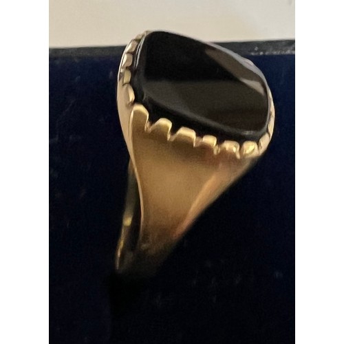 403 - A 9 carat gold ring set with black stone. size P. Weight 2.5gm.