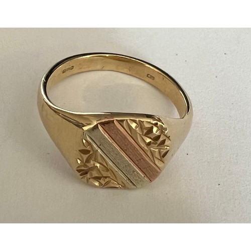 406 - A 9 carat gold signet ring with two tone gold decoration to top. Size O/P, weight 4.2gm.