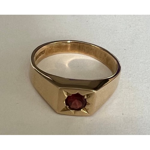 407 - A 9 carat gold ring set with single garnet. Weight 5gm, size P.