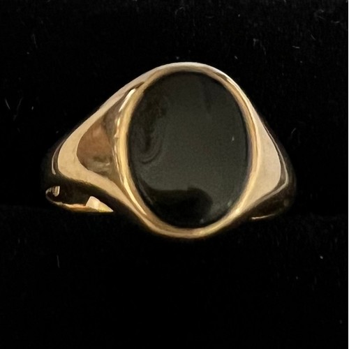 408 - A 9 carat gold ring set with oval black stone, size N, weight 1.7gm.