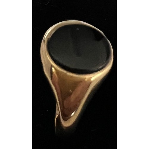 408 - A 9 carat gold ring set with oval black stone, size N, weight 1.7gm.