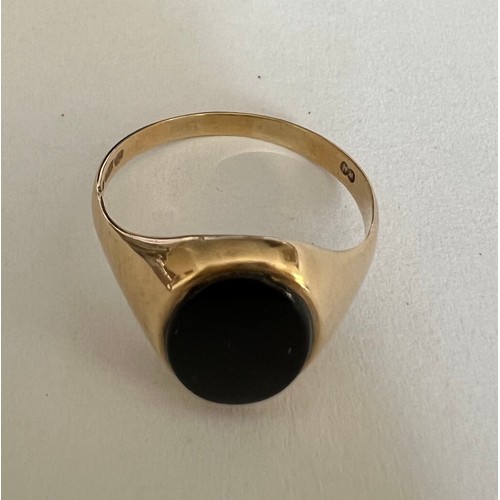 408 - A 9 carat gold ring set with oval black stone, size N, weight 1.7gm.