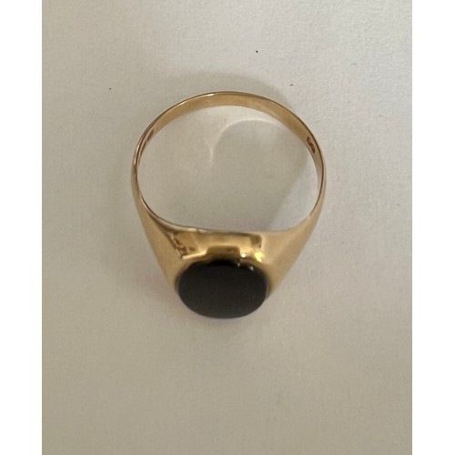 408 - A 9 carat gold ring set with oval black stone, size N, weight 1.7gm.