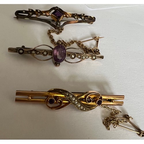 411 - Three Edwardian bar brooches set with seed pearls and purple stones. Two with safety chains. Total w... 