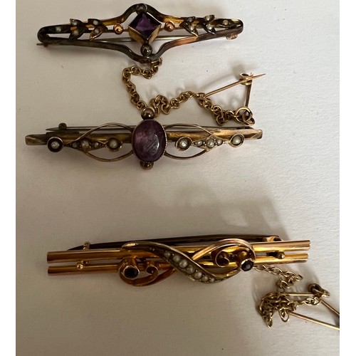 411 - Three Edwardian bar brooches set with seed pearls and purple stones. Two with safety chains. Total w... 