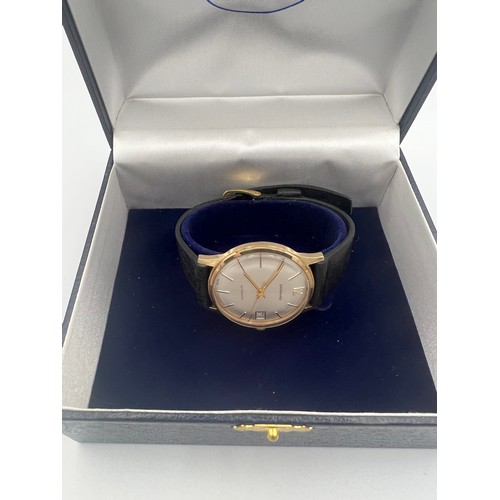 505 - A 9ct gold cased Garrard automatic date wristwatch with leather strap.

Winds and goes. Very good co... 