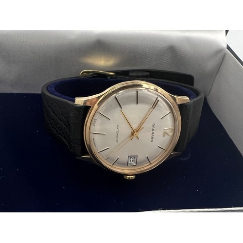 505 - A 9ct gold cased Garrard automatic date wristwatch with leather strap.

Winds and goes. Very good co... 