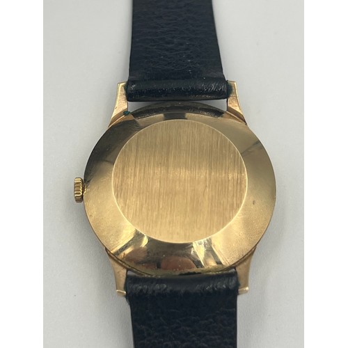 505 - A 9ct gold cased Garrard automatic date wristwatch with leather strap.

Winds and goes. Very good co... 