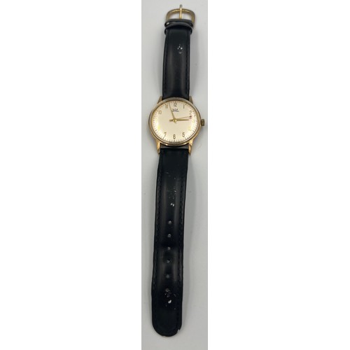 506 - An Astral 9ct gold cased automatic wristwatch with black leather strap.

Good condition, winds and r... 