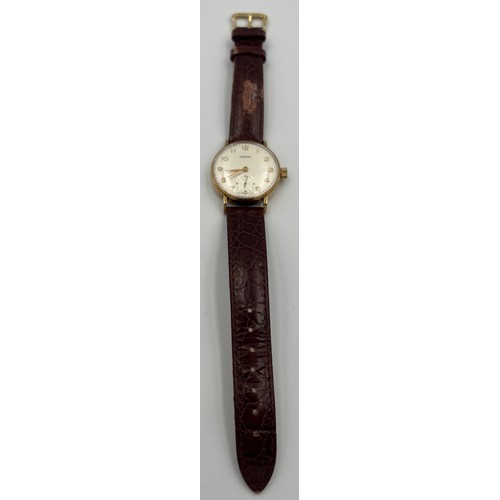 507 - A Vertex 9ct gold cased wristwatch with subsidiary seconds dial and brown leather strap.

Winds and ... 