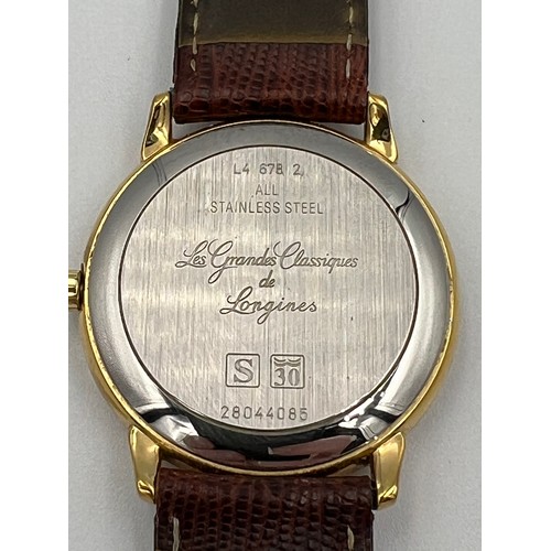 514 - A gentleman's Longines stainless steel wristwatch, with a champagne dial, raised batons, date apertu... 