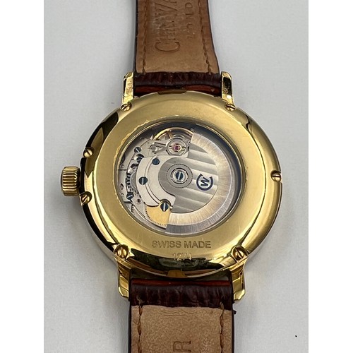 521 - A boxed Christopher Ward C5 GWK gentleman's date wristwatch on brown leather strap and skeleton back... 