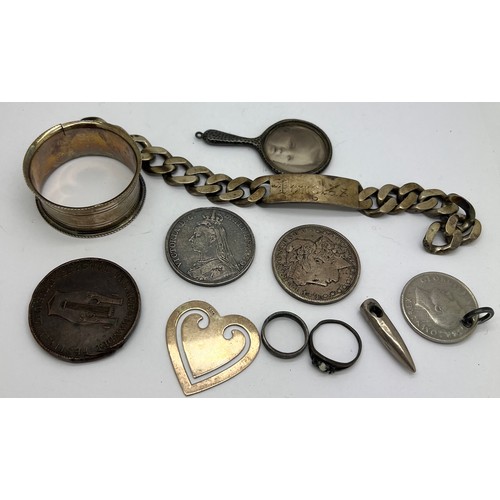 798 - A miscellany to include identity bracelet, hallmarked silver napkin ring, silver hand mirror photogr... 