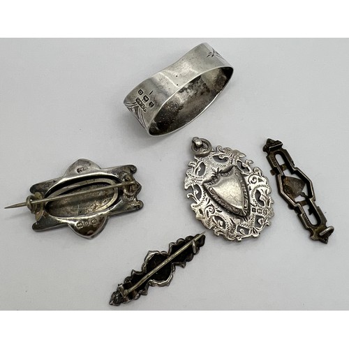 426 - Silver brooches, fob and ‘Baby’ napkin ring. Various dates and makers.