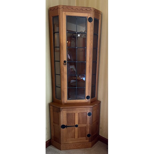 178 - Robert Thompson Mouseman corner display cabinet, the upper section with leaded glazed doors and shel... 