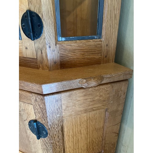 178 - Robert Thompson Mouseman corner display cabinet, the upper section with leaded glazed doors and shel... 