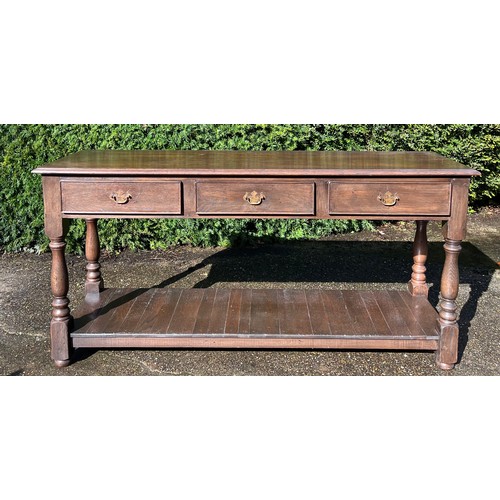 39 - Oak three drawer side table. 152cm w x 45 d x 75 h.