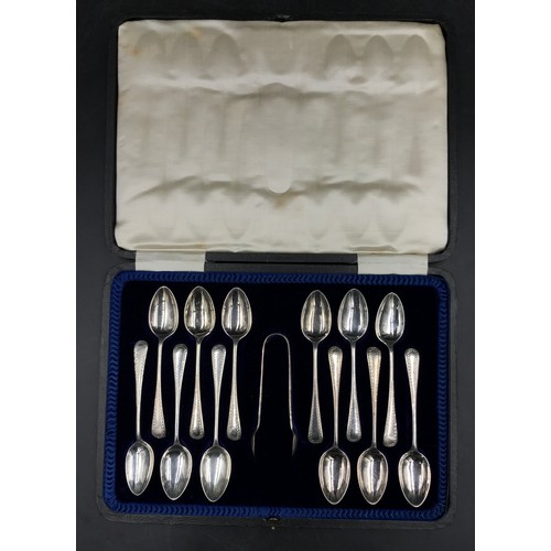 802 - Boxed set of twelve silver teaspoons and a pair of sugar tongs dated 1915 by Cooper Brothers & Sons,... 