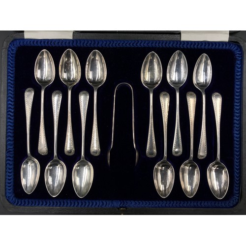 802 - Boxed set of twelve silver teaspoons and a pair of sugar tongs dated 1915 by Cooper Brothers & Sons,... 