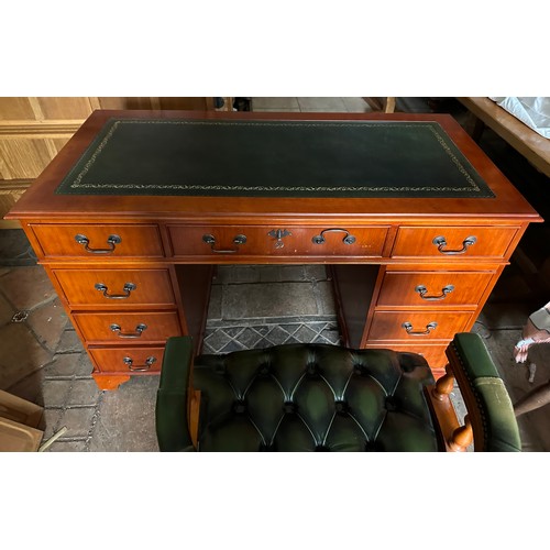 41 - A reproduction desk and swivel captains chair with leather button upholstery. 
221 w x 60.5 d x 76.5... 