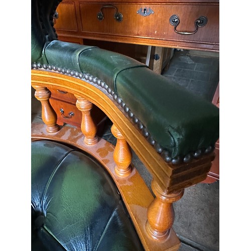 41 - A reproduction desk and swivel captains chair with leather button upholstery. 
221 w x 60.5 d x 76.5... 