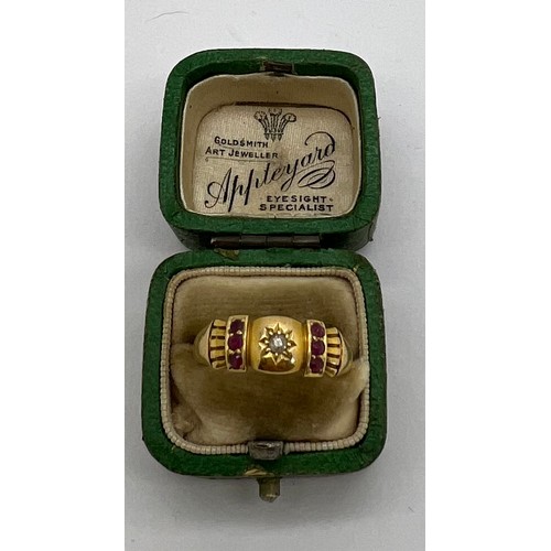 430 - An 18 carat gold ring set with two rows of rubies and a central diamond. In original presentation bo... 