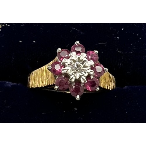 434 - An 18 carat gold cluster ring set with rubies and diamond with bark style decoration to the shank. W... 