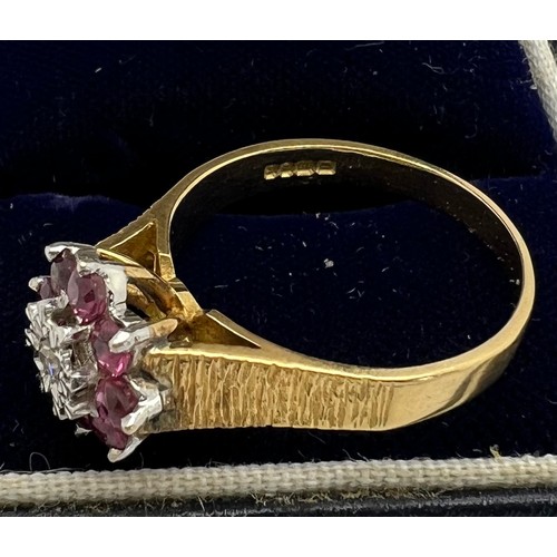 434 - An 18 carat gold cluster ring set with rubies and diamond with bark style decoration to the shank. W... 