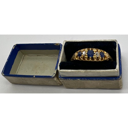 435 - An 18 carat gold ring set with sapphires and diamonds. Weight 3.5gm. Size R/S. In original presentat... 