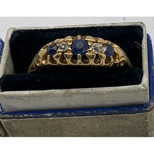 435 - An 18 carat gold ring set with sapphires and diamonds. Weight 3.5gm. Size R/S. In original presentat... 