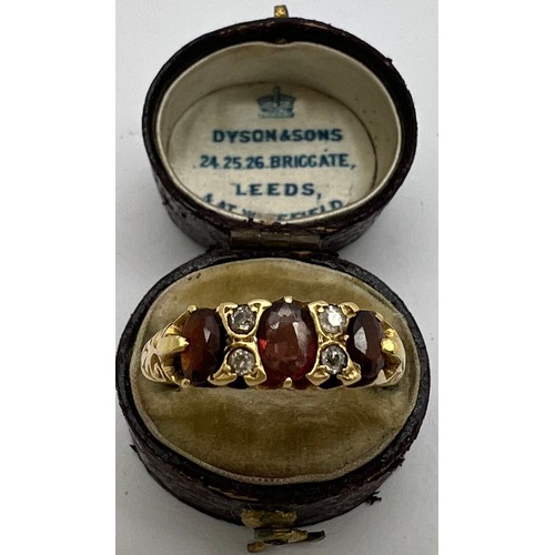 439 - A 22 carat gold ring set with garnets and diamonds in original presentation box. Weight 3.6gm. Size ... 