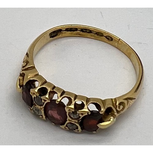 439 - A 22 carat gold ring set with garnets and diamonds in original presentation box. Weight 3.6gm. Size ... 