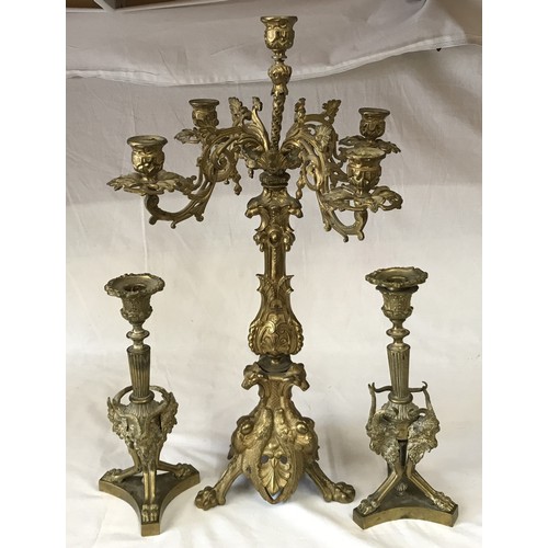 742 - A gilt metal five branch candelabra 58cm h, along with a pair of ornate brass candle sticks decorate... 