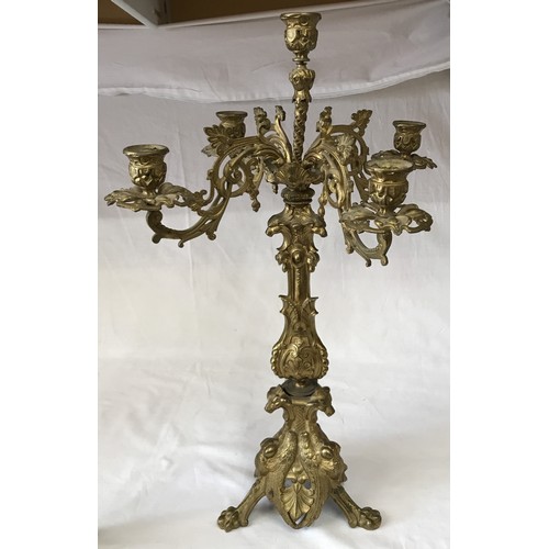 742 - A gilt metal five branch candelabra 58cm h, along with a pair of ornate brass candle sticks decorate... 