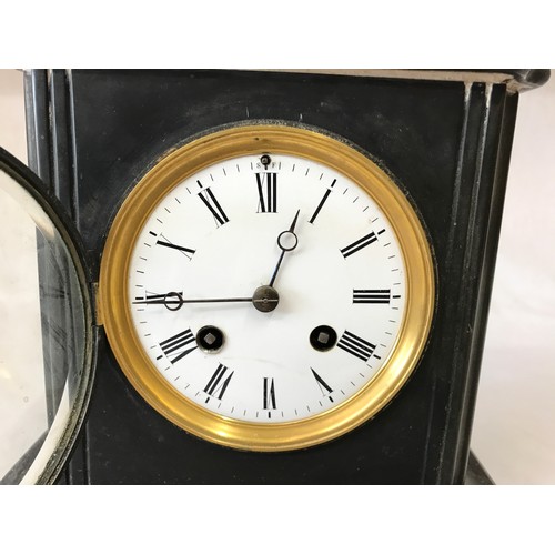 1017 - A late 19th century polished slate mantel clock, with an 8 day movement striking on a bell, stamped ... 