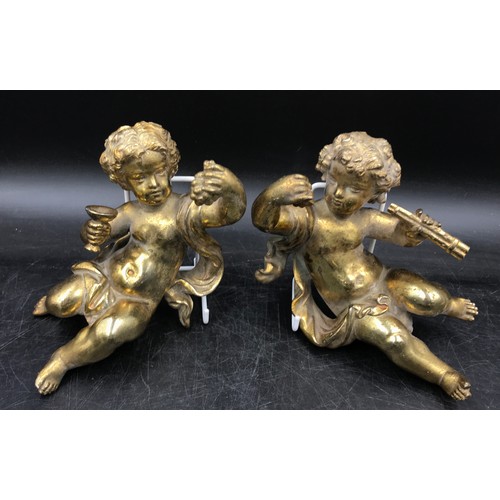 1005 - A collection of brass items to include a pair of matching cherubs, horn wrapped in leather, back scr... 