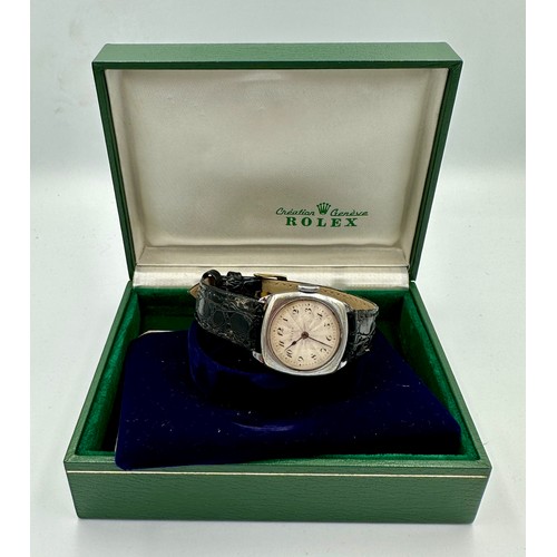 565 - A ladies stainless steel Rolex wristwatch on black leather strap and square case. In green Rolex box... 