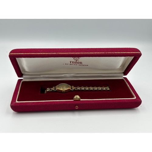 591 - A 9ct gold ladies Tudor wristwatch on rolled gold chain. Inner stamped 334025. B&S case made for Rol... 