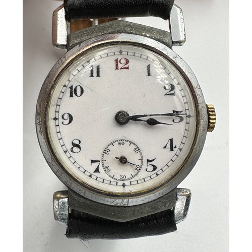 592 - An unsigned 1930's vintage hand winding gentleman's wristwatch with leather strap. Omega case. White... 