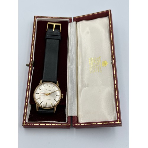 617 - A 9ct gold Rolex Tudor presentation watch on black leather Rolex strap. Presented to J.M. Platje by ... 