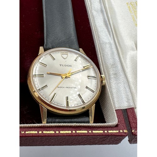 617 - A 9ct gold Rolex Tudor presentation watch on black leather Rolex strap. Presented to J.M. Platje by ... 