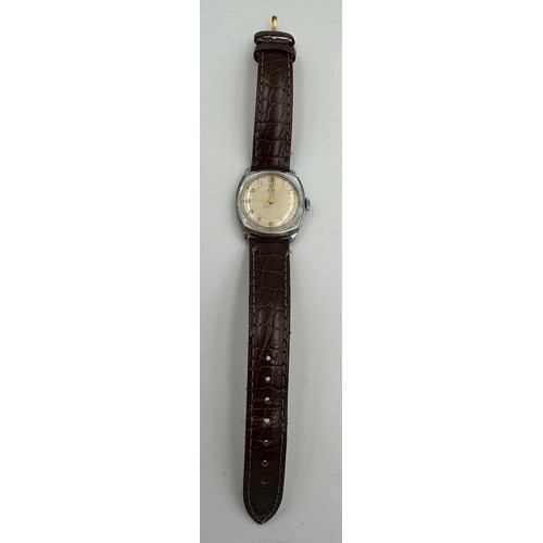 619 - A 1950's gentleman's Tudor cushion wristwatch on brown leather strap and Rolex buckle. Dennison case... 