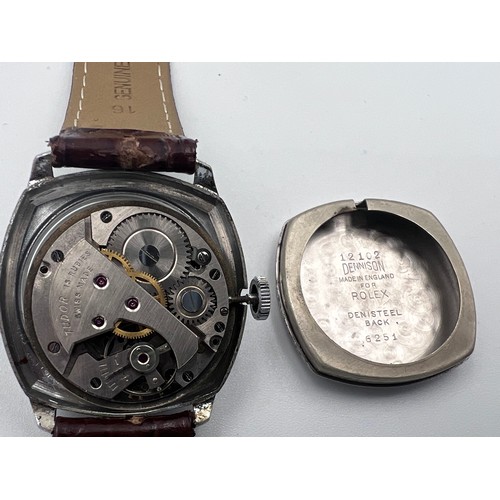 619 - A 1950's gentleman's Tudor cushion wristwatch on brown leather strap and Rolex buckle. Dennison case... 