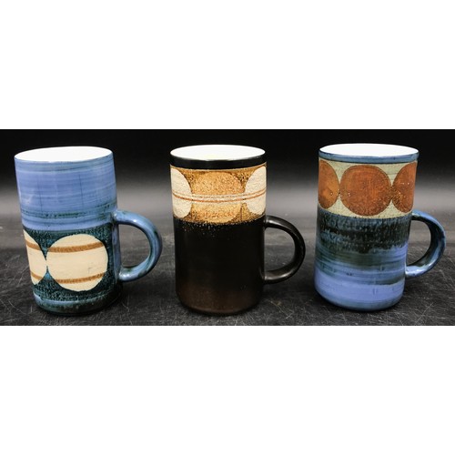 238 - A collection of three Troika mugs to include one by Avril Bennett signed A B to base, one by Marilyn... 