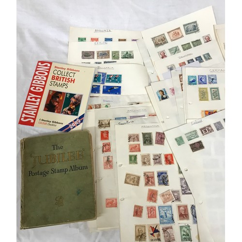 668 - A file of world stamps mounted on pages along with jubilee printed album, some loose stamps on paper... 